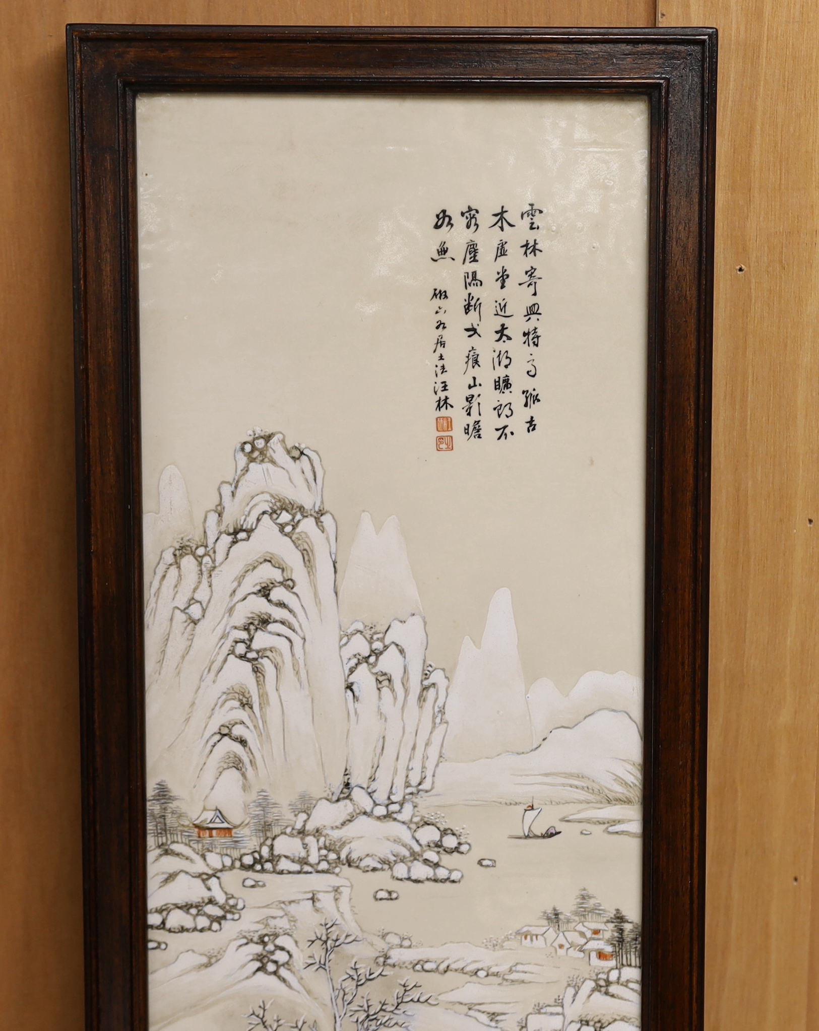 An early 20th century Chinese enamelled porcelain 'winter scene' plaque, framed, 85 x 25cm total